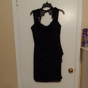 Black, mid length, semi-formal dress.